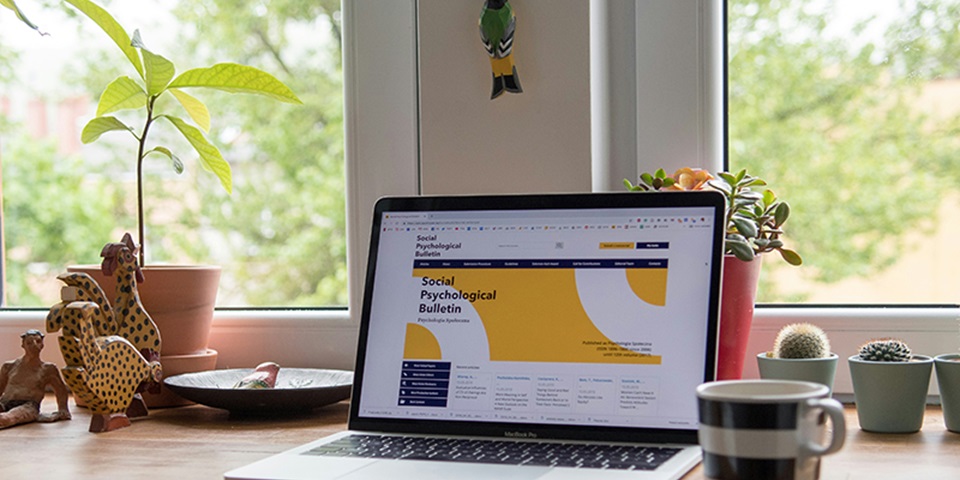 An open laptop on a desk displaying a journal article