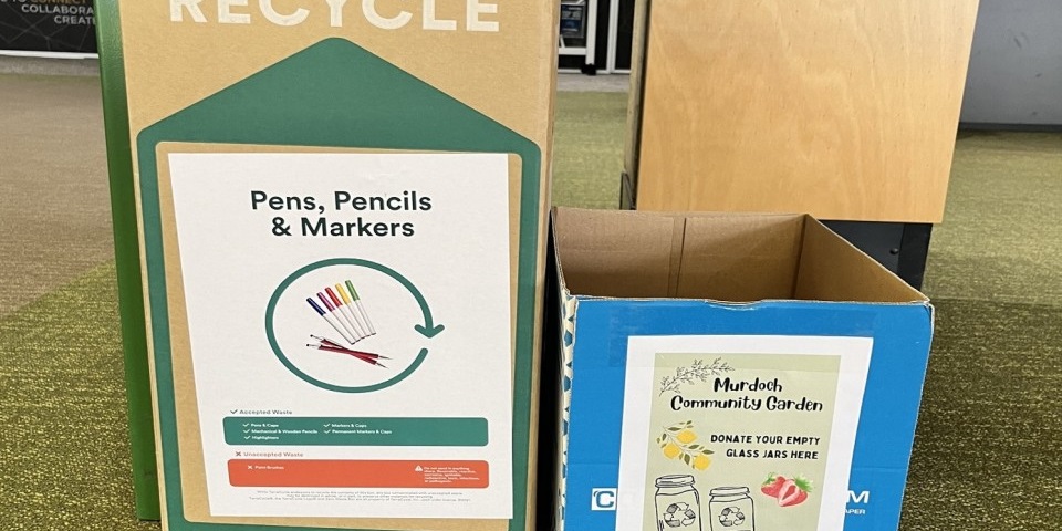boxes with signs to collect jars and pens for recycling