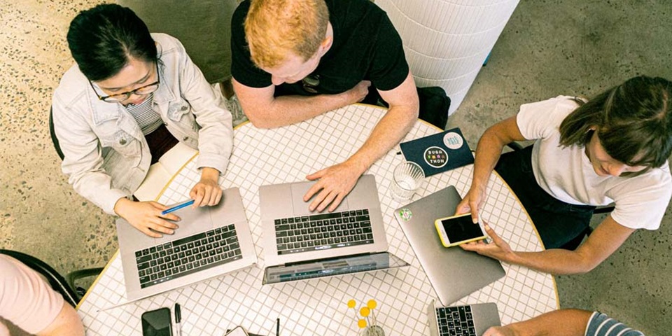 People at a table with laptops