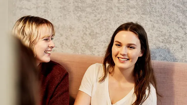 Two students in a study booth at the Library