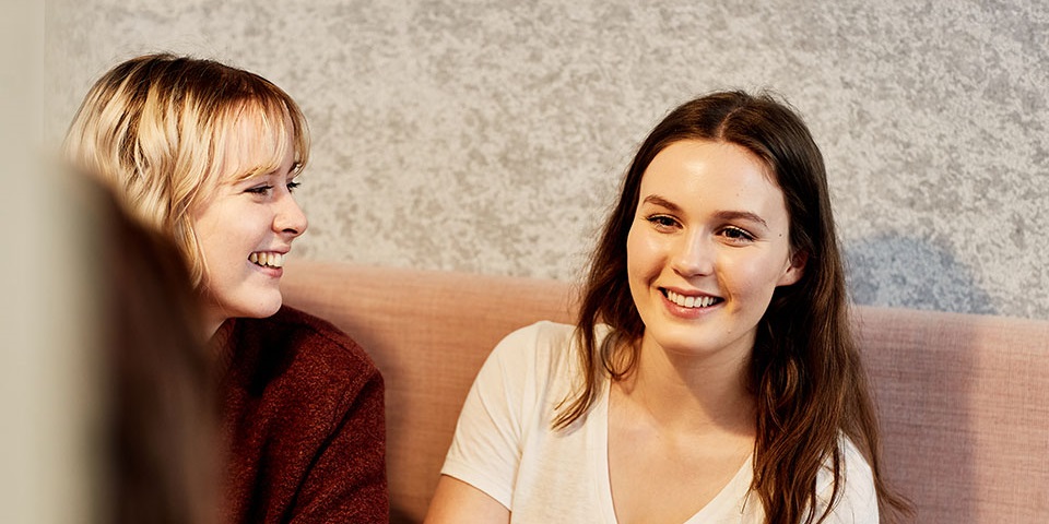 Two students in a study booth at the Library