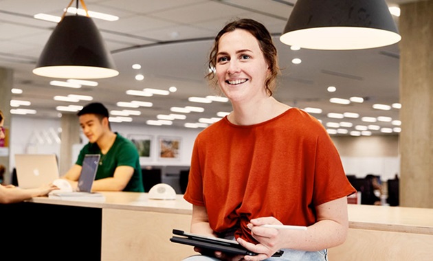 Student in learning common holding an iPad