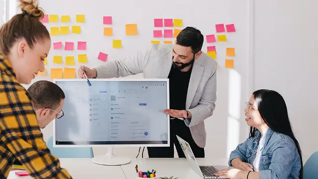 Man showing student a computer screen of information