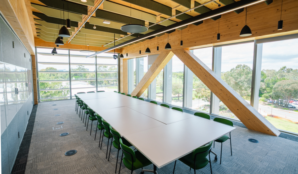 Office with large table and green chairs