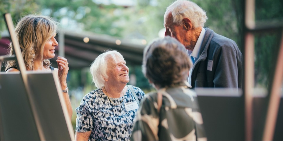 A multi-generational family stand around talking