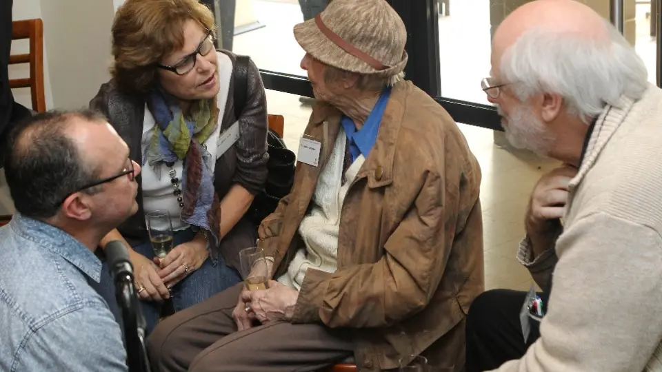 A multi-generational family engage in a discussion