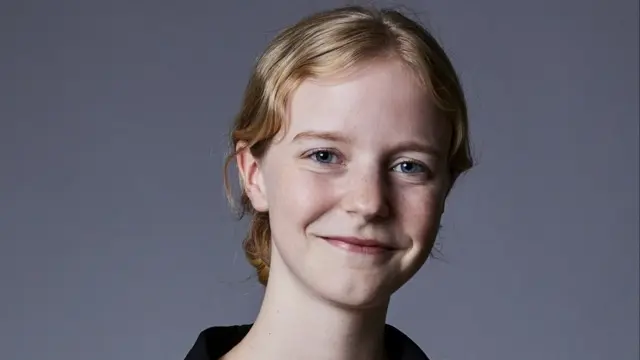 A young woman smiling at the camera