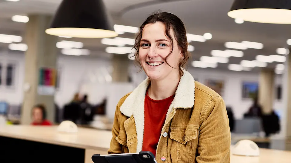student smiling in library