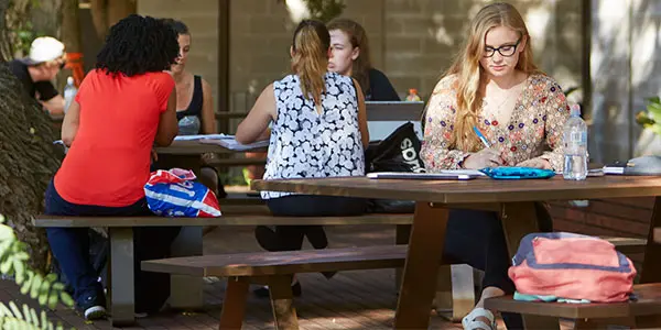 Students sitting on outdoor tables