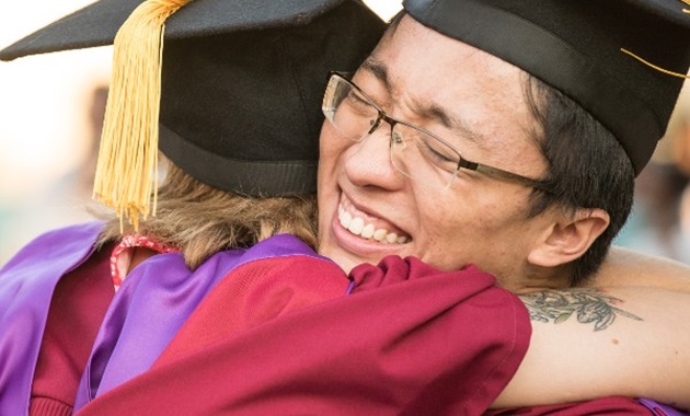 Graduates hugging