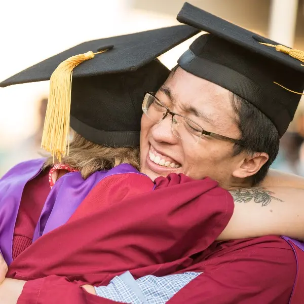 Graduates hugging
