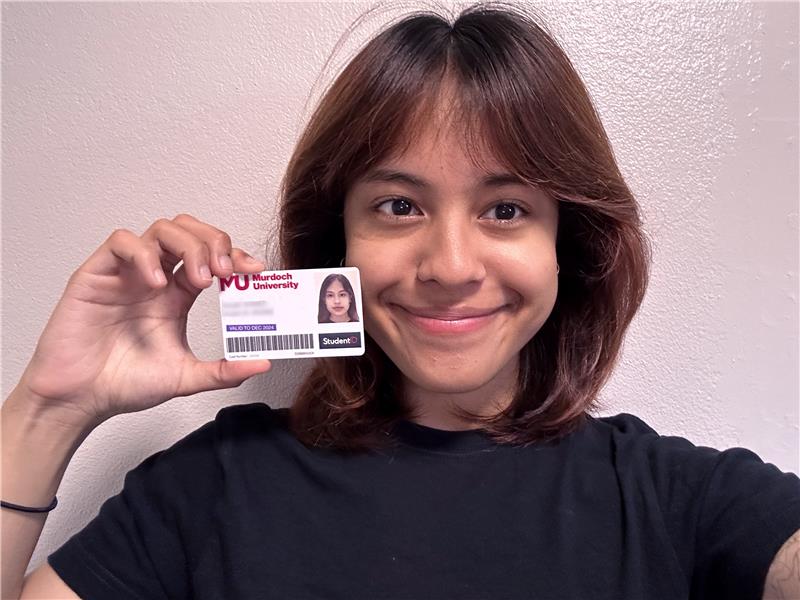 Murdoch University student holding Student ID Murdoch University student holding Student ID