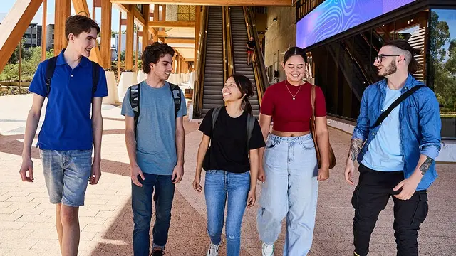 5 students walking in front of Boola Katitjin building