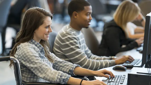 students looking at computer