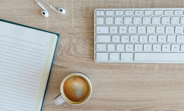 desk setup with coffee and keyboard