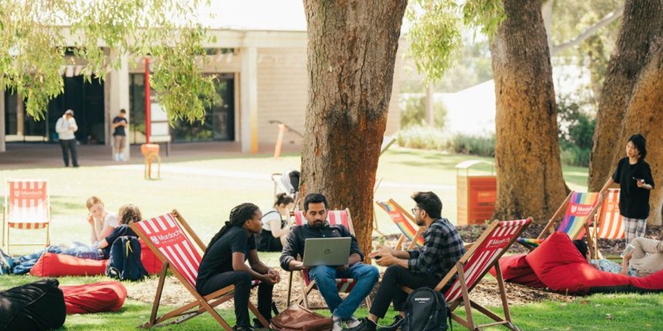 10 things people don't tell you about uni A group of Murdoch students studying outside on deck chairs in Bush Court