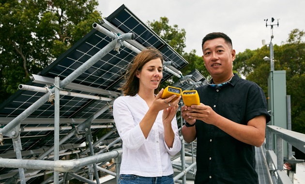 Engineering and Energy students in front of solar panels
