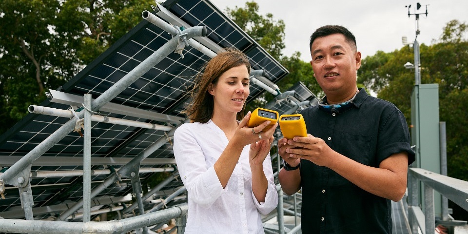 Engineering and Energy students in front of solar panels