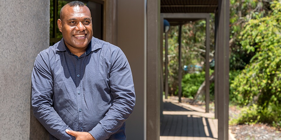 PNG student Benson Hahambu smiling outside