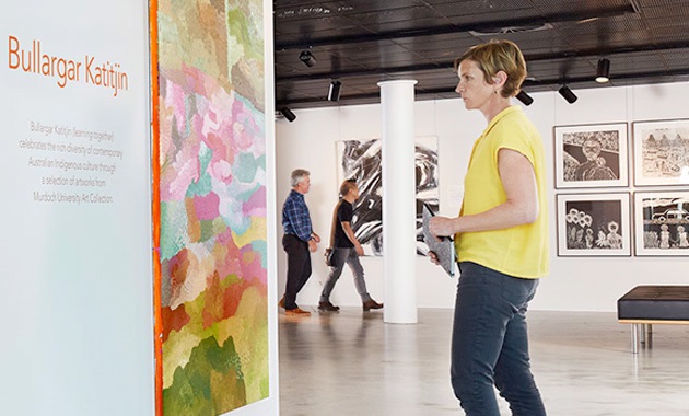 Woman looking at art piece in gallery