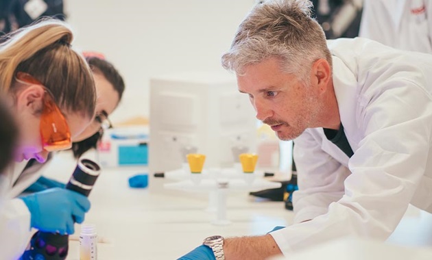 Senior Lecturer Brendan Chapman with his students in the lab