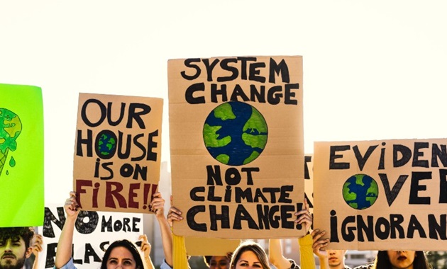 A group of climate activists holding up posters and banners.
