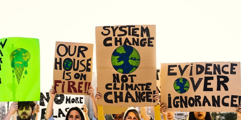 A group of climate activists holding up posters and banners.