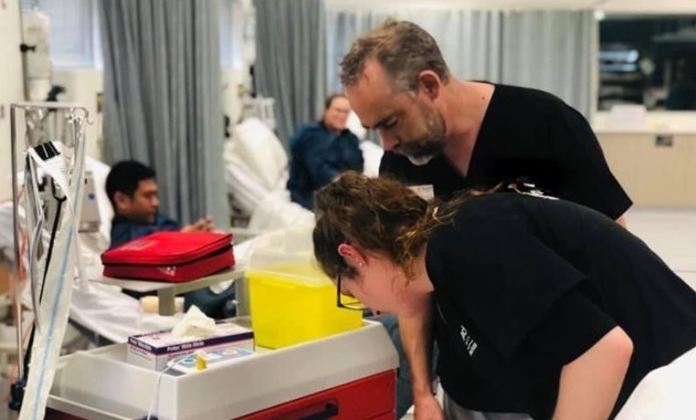 Teacher and student work in a simulated hospital room