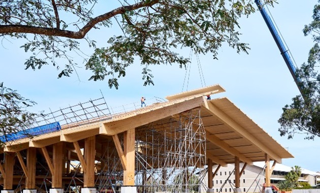 Crane lifting the final piece of timber onto the Northern Plaza of Boola Katitjin