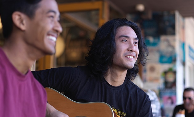 Daniel playing guitar with a friend