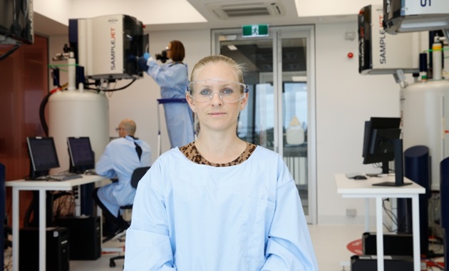 Scientist smiling at camera in lab