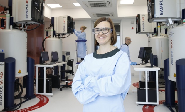 Dr Nicola Gray stands in front of the NMR suite at the Australian National Phenome Centre