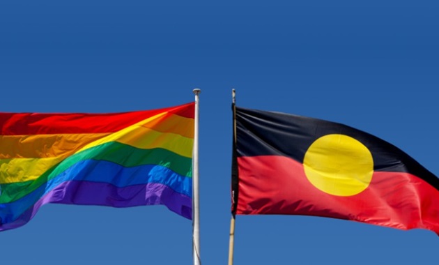 Pride flag and indigenous flag side by side