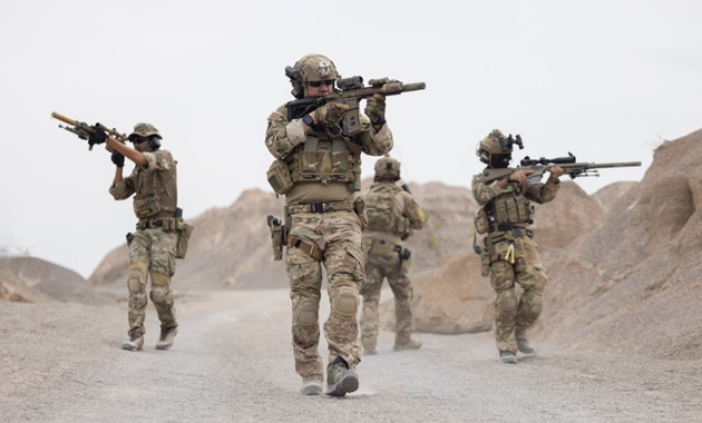 Soldiers on a patrol in Afghanistan. (Credit: charnsitr/Getty Images)
