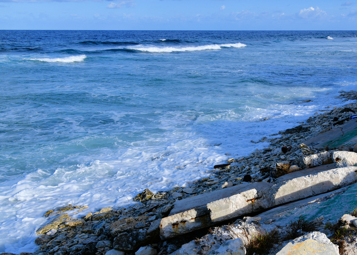 The remains of a collapsed seawall due to rising sea levels in Tuvalu in the Pacific. The remains of a collapsed seawall due to rising sea levels in Tuvalu in the Pacific.
