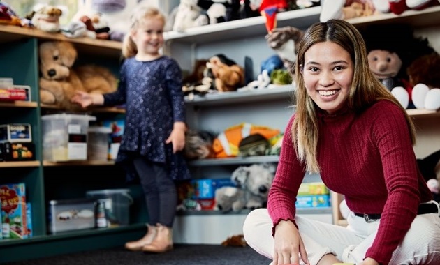 Child and student smile to camera in a classroom