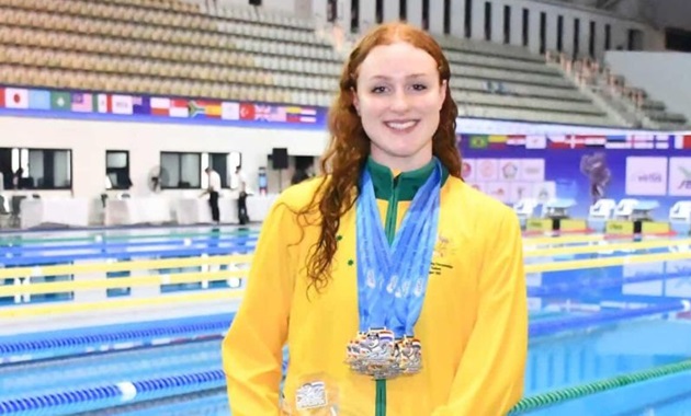 Murdoch University’s Elite Athlete swimmer now holds nine golds and nine world records Murdoch University Elite Athlete Kate Wallington at the 2025 Virtus World Swimming Championships in Bangkok with medals around her neck and holding a trophy. She's standing in front of a swimming pool that is split into lanes for racing.