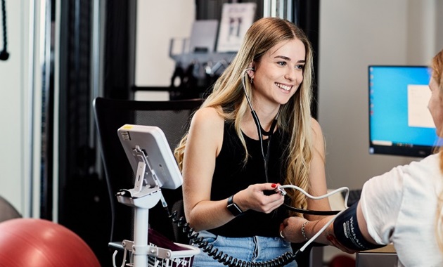 Murdoch student takes patient's blood pressure