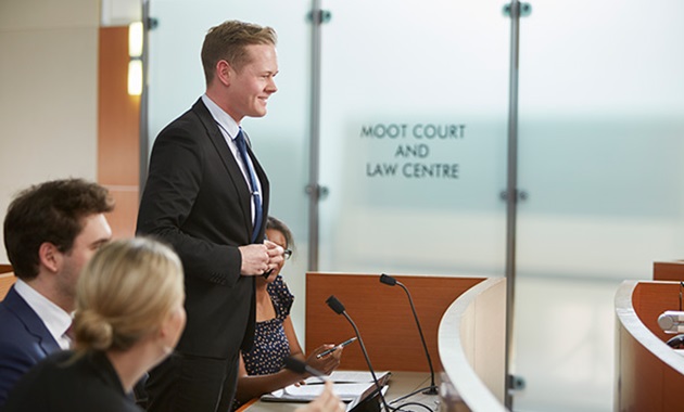 Male student presents in the Moot Court and Law Centre.