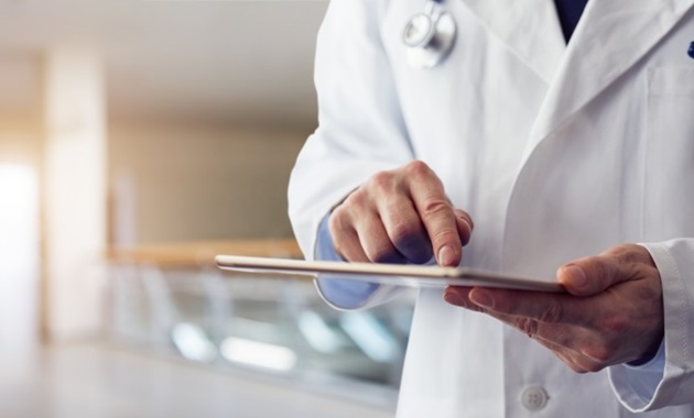 male doctor's hands on tablet