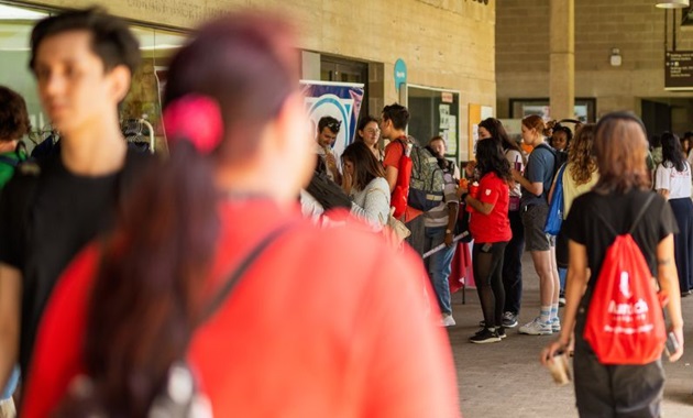People gathering on Murdoch University's campus outside of the library.