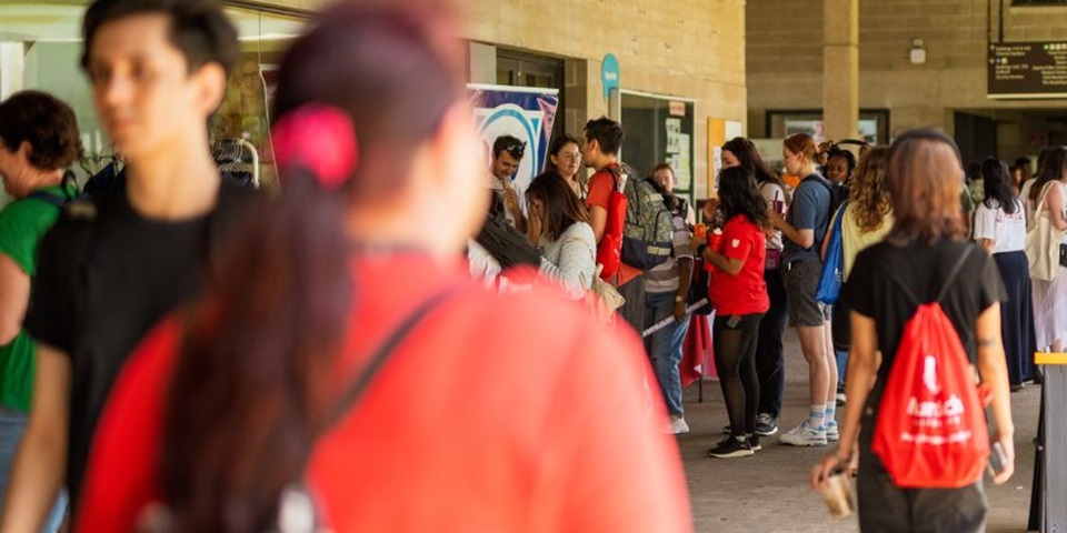 People gathering on Murdoch University's campus outside of the library.