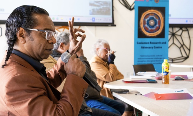 Man speaking into a microphone at the water roundtable event