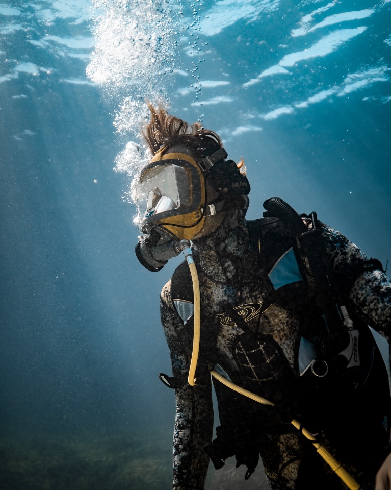 Kurt Krispyn underwater in a diving suit.