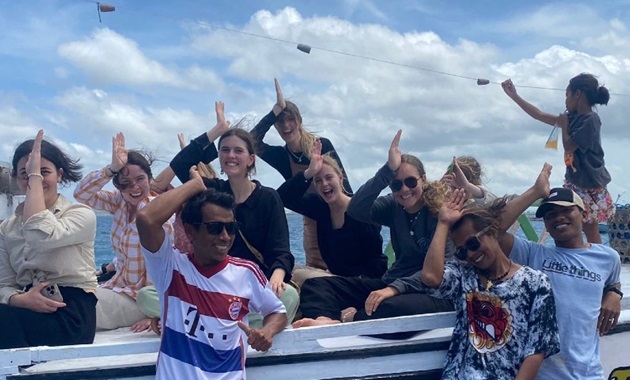 Undergraduate students in Indonesia working on Project Hiu. Students smiling holding their hands like fins on their head.