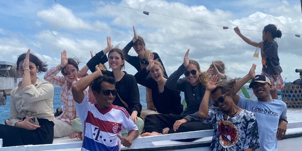 Undergraduate students in Indonesia working on Project Hiu. Students smiling holding their hands like fins on their head.