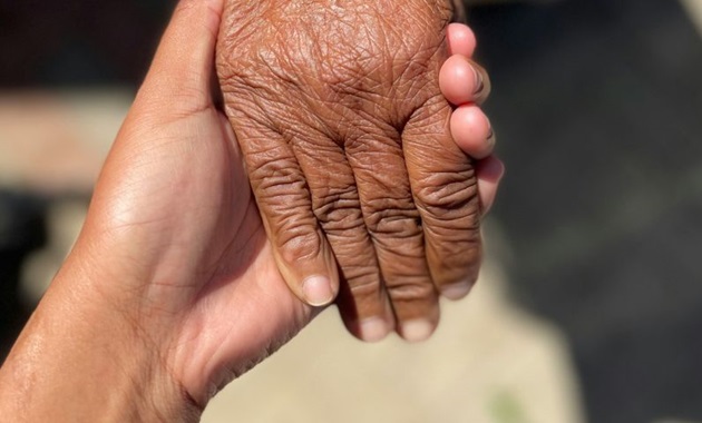 Two people holding hands