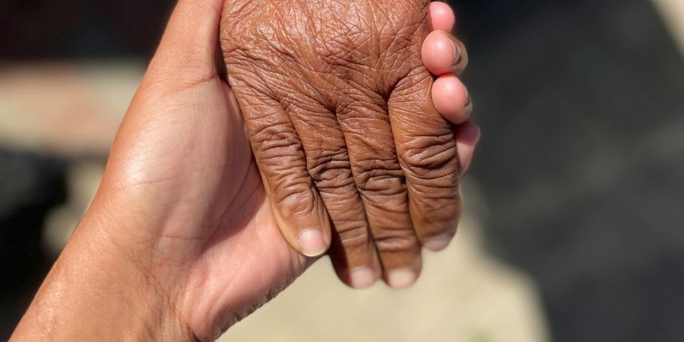 Two people holding hands