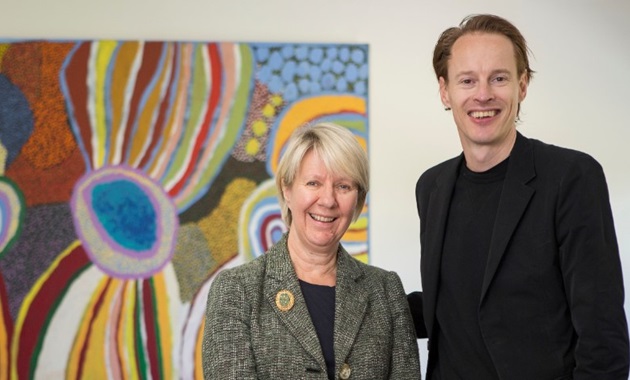 Vice Chancellor Eeva Leinonen with Daan Roosegaarde standing in front of a painting