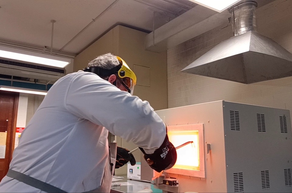 Photo of a HBI researcher operating furnace